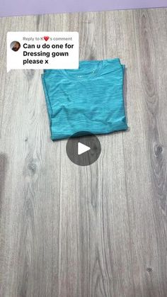 a t - shirt laying on top of a wooden floor