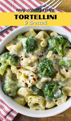 a bowl filled with tortelli and broccoli on top of a table