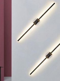 two lights that are on the side of a wall