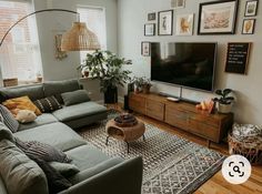 a living room filled with furniture and a large flat screen tv mounted on the wall