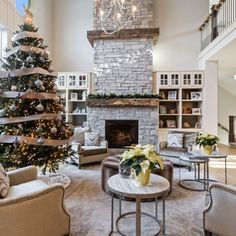 a living room filled with furniture and a christmas tree in the middle of the room