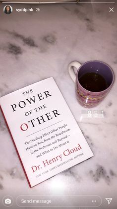 the power of the other book next to a cup of coffee on a marble table