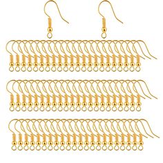 four pairs of gold earrings with chains hanging from the ends and beads on each side