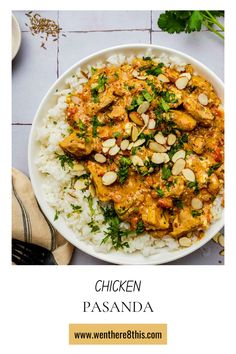 chicken paasunda with almonds and parsley in a white bowl on top of rice