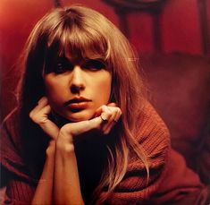 a woman with long hair and bangs posing for a photo