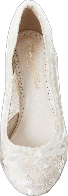 a pair of white shoes with lace on them