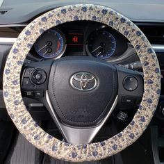 the steering wheel cover is decorated with blue flowers