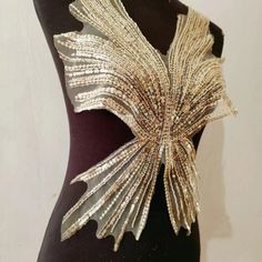 a mannequin with gold and silver sequins on it's back