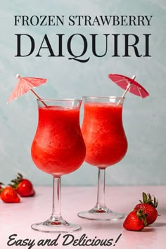 two glasses filled with frozen strawberry daiquiri next to strawberries