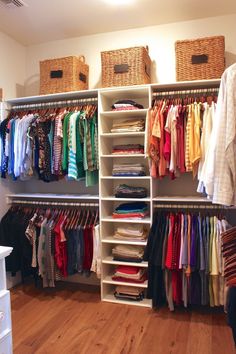 an organized closet with clothes and baskets