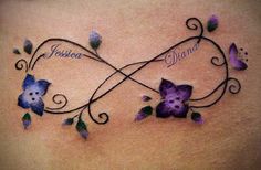 a woman's stomach with an artistic tattoo design on it