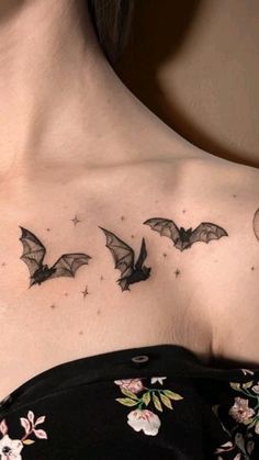 a woman's chest with bats and flowers on it