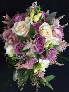 a bouquet of pink and white flowers on a black background