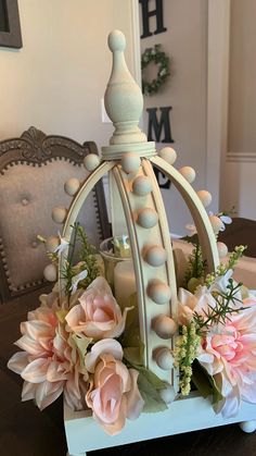 a white candle holder with flowers and candles