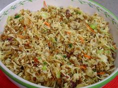 a bowl filled with coleslaw and carrots on top of a table