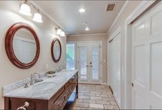 a large bathroom with double sinks and mirrors