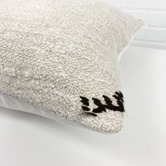 a white pillow with an animal print on the side and black writing on the back