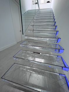 an artistic staircase with glass steps leading up to the top