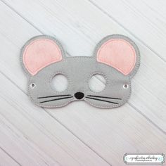 a gray mask with pink ears on it