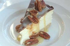 a piece of cheesecake with pecans on top