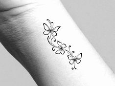 a black and white photo of a butterfly tattoo