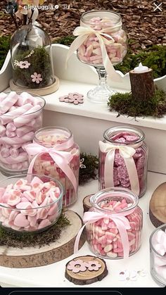 a table topped with lots of pink and white candies