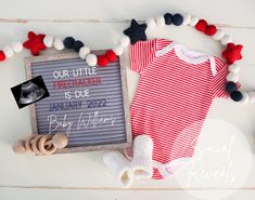 a baby's red and white bodysuit is next to a sign that says our little threader is due