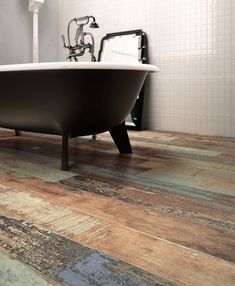 a bath tub sitting on top of a wooden floor