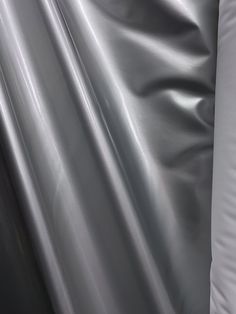 an up close shot of a shiny silver sheet covering the surface of a bed or couch