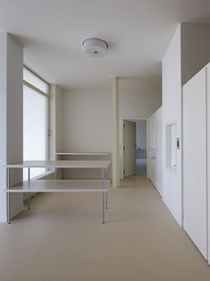 an empty room with white walls and shelves