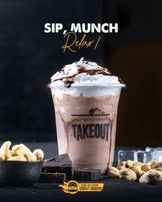 there is a drink with whipped cream on top and chocolate in the bottom, surrounded by nuts