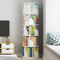 a bed room with a neatly made bed and a tall book shelf filled with books