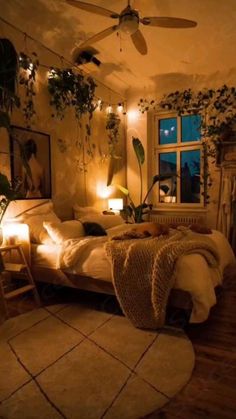 a bed room with a neatly made bed next to a window and a ceiling fan