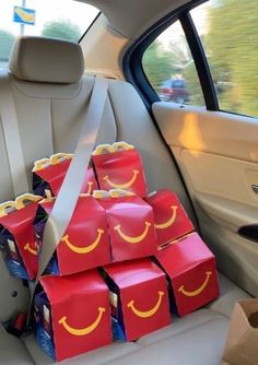 a bunch of boxes in the back seat of a car with smiley faces on them