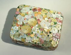 a box with flowers on it sitting on a table