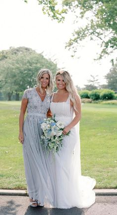 two women in dresses standing next to each other