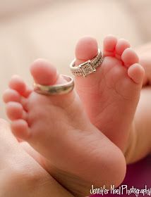 a baby's feet with two rings on top of it and the bottom of their toes