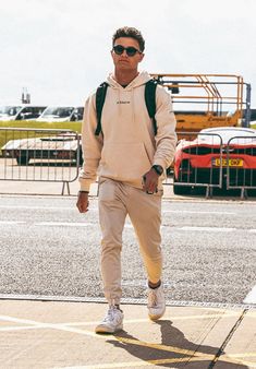 a man walking down the street wearing sunglasses