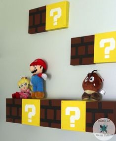 some stuffed animals are sitting on top of shelves with question mark above them and below them is an image of mario