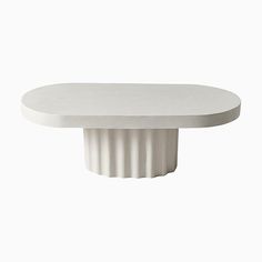 a white table with an oval shaped base