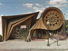 a large wooden structure sitting on the side of a road