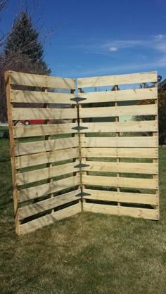 a large wooden fence sitting in the grass