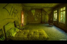 an abandoned bedroom with graffiti on the walls