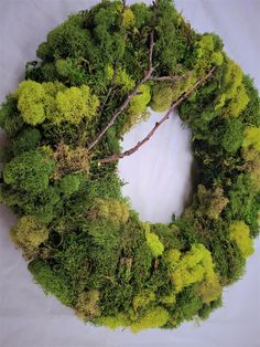 a wreath made out of moss and trees