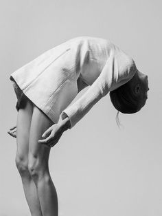 black and white photograph of a woman doing a handstand