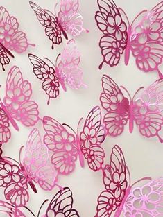 many pink butterflies on a white surface