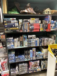 the shelves are full of dvds and other items for sale in a store or bookstore