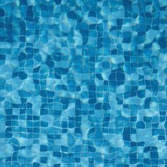 an empty swimming pool with blue tiles on the bottom and water reflecting off it's surface