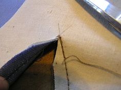 someone is cutting through the fabric with a pair of scissors to sew on it