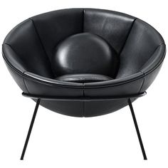 a black leather chair with metal legs and a round seat on the back, in front of a white background